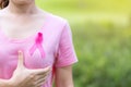 October Breast Cancer Awareness month, adult Woman in pink T- shirt and Pink Ribbon for supporting people living and illness. Royalty Free Stock Photo