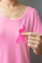 October Breast Cancer Awareness month, elderly Woman in pink T- shirt with hand holding Pink Ribbon for supporting people living Royalty Free Stock Photo