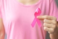 October Breast Cancer Awareness month, elderly Woman in pink T- shirt with hand holding Pink Ribbon for supporting people living Royalty Free Stock Photo