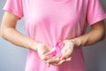 October Breast Cancer Awareness month, elderly Woman in pink T- shirt with hand holding Pink Ribbon for supporting people living Royalty Free Stock Photo