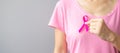 October Breast Cancer Awareness month, elderly Woman in pink T- shirt with hand holding Pink Ribbon for supporting people living Royalty Free Stock Photo