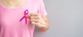 October Breast Cancer Awareness month, elderly Woman in pink T- shirt with hand holding Pink Ribbon for supporting people living Royalty Free Stock Photo