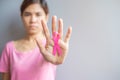 October Breast Cancer Awareness month, elderly Woman in pink T- shirt with hand holding Pink Ribbon for supporting people living Royalty Free Stock Photo