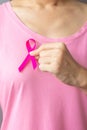 October Breast Cancer Awareness month, elderly Woman in pink T- shirt with hand holding Pink Ribbon for supporting people living Royalty Free Stock Photo