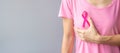 October Breast Cancer Awareness month, elderly Woman in pink T- shirt with hand holding Pink Ribbon for supporting people living Royalty Free Stock Photo