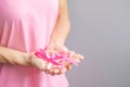 October Breast Cancer Awareness month, elderly Woman in pink T- shirt with hand holding Pink Ribbon for supporting people living Royalty Free Stock Photo