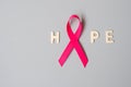 October Breast Cancer Awareness month, Pink Ribbon with HOPE text on grey background for supporting people living and illness.