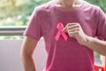 October Breast Cancer Awareness month, Woman in pink T- shirt with hand holding Pink Ribbon for supporting people living and Royalty Free Stock Photo