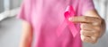 October Breast Cancer Awareness month, Woman in pink T- shirt with hand holding Pink Ribbon for supporting people living and Royalty Free Stock Photo