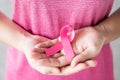 October Breast Cancer Awareness month, Woman in pink T- shirt with hand holding Pink Ribbon for supporting people living and Royalty Free Stock Photo