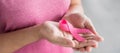 October Breast Cancer Awareness month, Woman in pink T- shirt with hand holding Pink Ribbon for supporting people living and Royalty Free Stock Photo