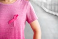 October Breast Cancer Awareness month, Woman in pink T- shirt with Pink Ribbon for supporting people living and illness.