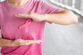 October Breast Cancer Awareness month, Woman in pink T- shirt with Pink Ribbon for supporting people living and illness. Royalty Free Stock Photo