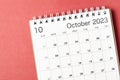 A October 2023 calendar desk for the organizer to plan and reminder isolated on red background Royalty Free Stock Photo