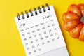 The October 2023 Calendar and pumpkins on yellow background