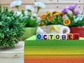 October. Colorful cube letters on sticky note block.