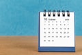 The October 2023 desk calendar on blue color background