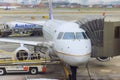 Before next takeoff passenger plane is being serviced by ground services near boarding gate