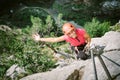 Young woman who is climbing along a via ferrata