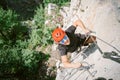 Young man who is climbing along a via ferrata