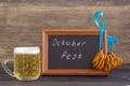 October fest concept. Beer mug with snacks of salt pritzels, bretzel and board with the words