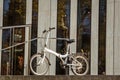 October 27, 2018. Germany, Dusseldorf. City folding bicycle parked background building complex known K -Bogen City Center,