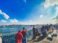 October 27, 2019 Istanbul. Turkey. Fisherman fishing on the Galata Bridge in Istanbul Turkey. People walk on Galata bridge. Royalty Free Stock Photo