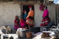 Quechua Indian Woman And Her Family Dressed In Colorful Handwoven Outfit And Standing Outside Their House
