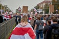 October 4 2020 Minsk Belarus A protesting woman wrapped in a flag walks during a demonstration