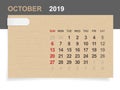 October 2019 - Monthly calendar on brown paper and wood background with area for note.