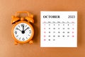 The October 2023 Monthly calendar for the organizer to plan 2023 year with alarm clock on yellow background Royalty Free Stock Photo