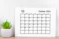 The October 2023 monthly calendar for 2023 on wooden background
