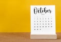 The October 2023 Monthly calendar for 2023 year on yellow table