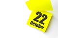 October 22nd. Day 22 of month, Calendar date. Close-Up Blank Yellow paper reminder sticky note on White Background. Autumn month, Royalty Free Stock Photo