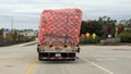 A semi tractor trailer load appears to be leaning a bit.