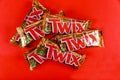 Twix bars cookie chocolate made by Mars, Inc. on red background