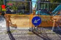 October 2020 Parma, Italy: Construction on road close-up across city architecture. Road sign arrow close-up