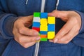 Rubik`s cube in female hands - game for solving problems Royalty Free Stock Photo