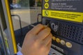 October 2020 Reggio Emilia, Italy: Male hands putting money in parking meter close-up. Paying for parking Royalty Free Stock Photo