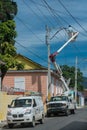 Dramatic image of power line workers in the caribbean, dominican republic.