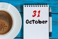 October 31st. Day 31 of month, calendar and hot coffee cup at translator or interpreter workplace background. Autumn