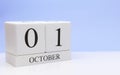 October 01st. Day 1 of month, daily calendar on white table with reflection, with light blue background. Autumn time, empty space Royalty Free Stock Photo