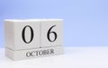 October 06st. Day 6 of month, daily calendar on white table with reflection, with light blue background. Autumn time, empty space Royalty Free Stock Photo