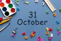 October 31st. Day 31 of october month, calendar on teacher or student table, blue background . Autumn time