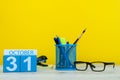 October 31st. Day 31 of october month, wooden color calendar on teacher or student table, yellow background . Autumn