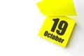 October 19th. Day 19 of month, Calendar date. Close-Up Blank Yellow paper reminder sticky note on White Background. Autumn month,