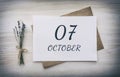 October 07. 07th day of the month, calendar date.White blank of paper with a brown envelope, dry bouquet of lavender flowers on a