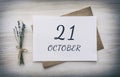 October 21. 21th day of the month, calendar date.White blank of paper with a brown envelope, dry bouquet of lavender flowers on a