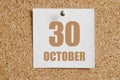 october 30. 30th day of the month, calendar date.White calendar sheet attached to brown cork board.Autumn month, day of Royalty Free Stock Photo