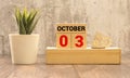 october 3. 3th day of month, calendar date.White vase with dead wood next to cork board with numbers Royalty Free Stock Photo